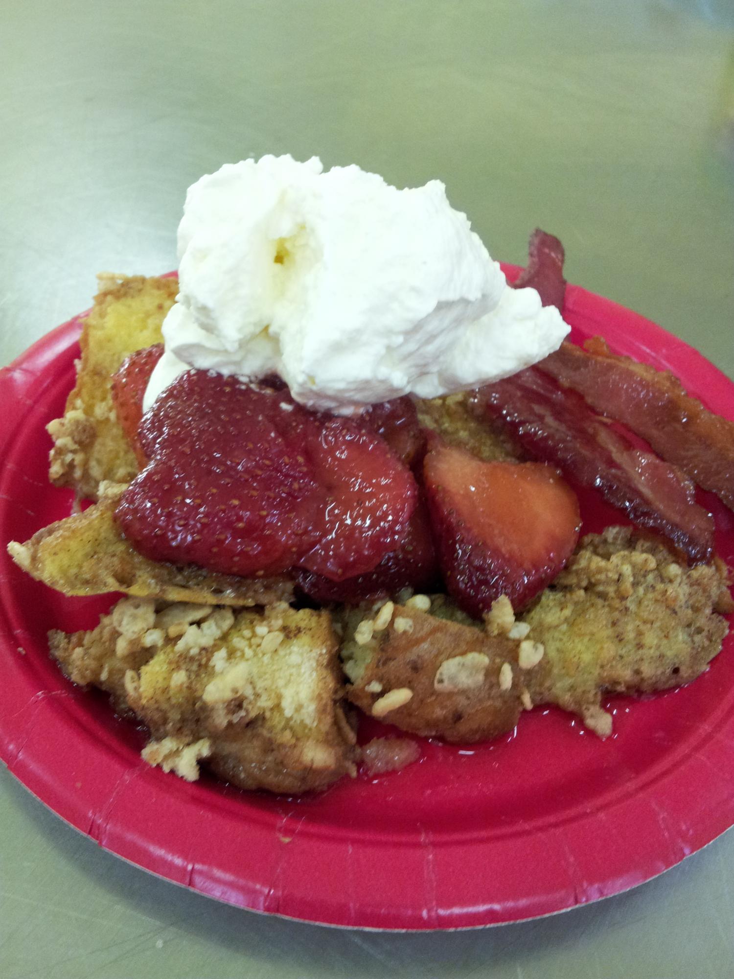 French Toast Sticks rolled in crispy rice cereal and cinnamon sugar.  Baked to perfection and served with Strawberry Compote and Homemade Whipped Cream